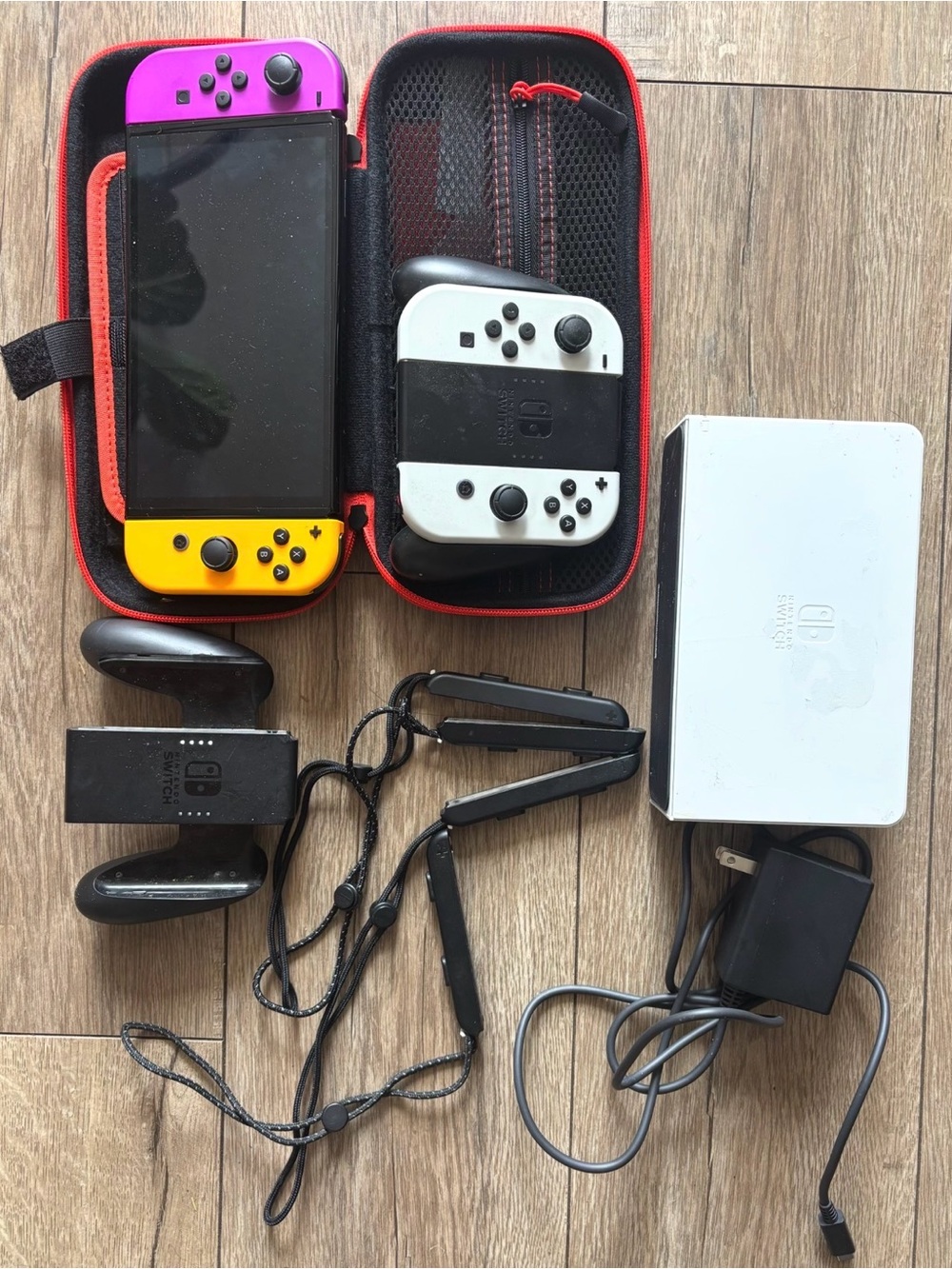 Nintendo Switch with Bright Pink & Yellow Joy‑Con and White Controllers